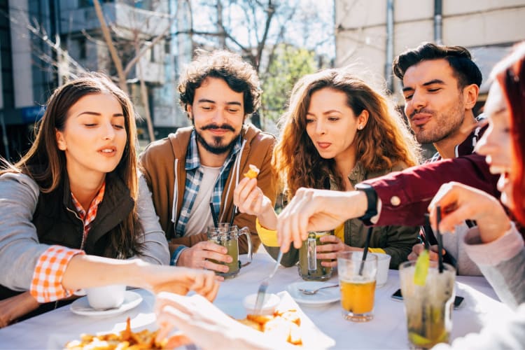 friends eating and laughing at a restaurant