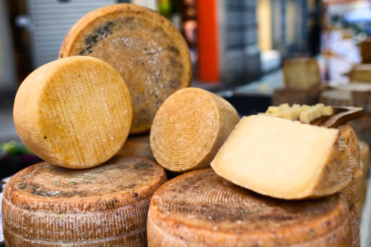 Wheels of aged pecorino with one cut open