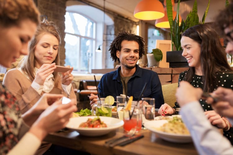 Young people having dinner at a restaurant in St. Louis