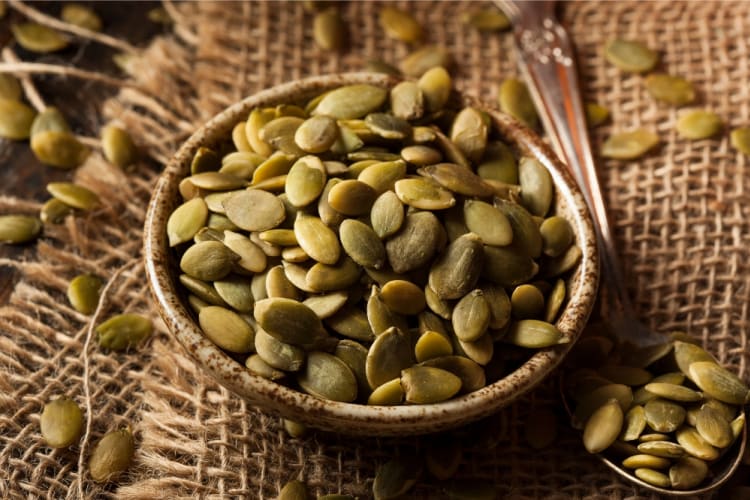 A bowl full of green pepitas