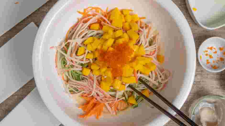 Kani Salad Recipe: Add Kani, cucumber strips, carrot strips, diced mango and salmon roe to the bowl.