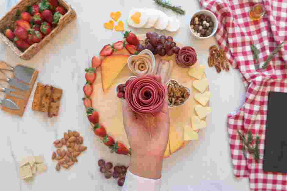 Date Night Charcuterie Board Recipe: Cut 2 slices of smoked turkey in half, and wrap the turkey around the grissini breadsticks.