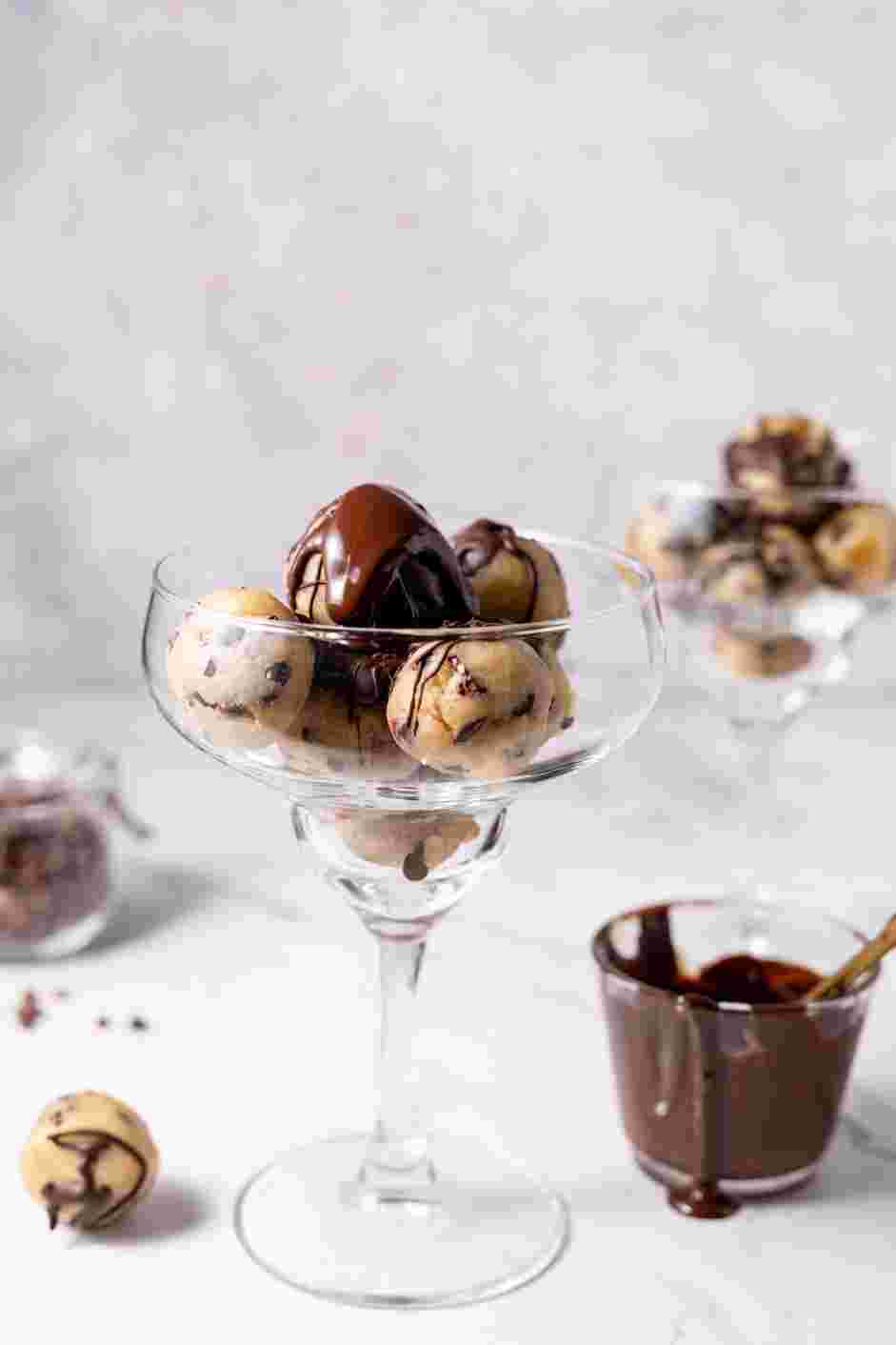 Vegan Cookie Dough Recipe: Serve the vegan cookie dough in small bowls or dishes topped with chocolate sauce.