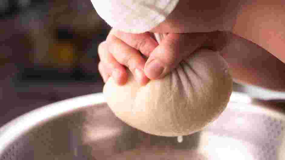 German Potato Pancakes Recipe: Wrap the potatoes with the cheesecloth and firmly squeeze out any excess moisture.