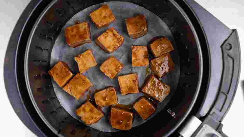 Air Fryer Tofu Recipe: Drain excess marinade and arrange tofu in the air fryer basket.