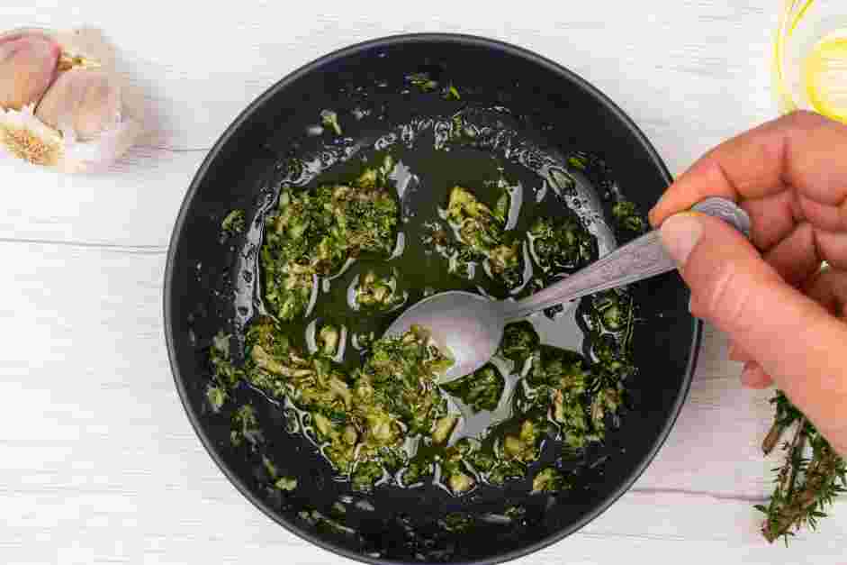 Tomato Confit Recipe: Remove the thyme leaves from the stems and place them into a mortar and pestle with the garlic cloves and salt.