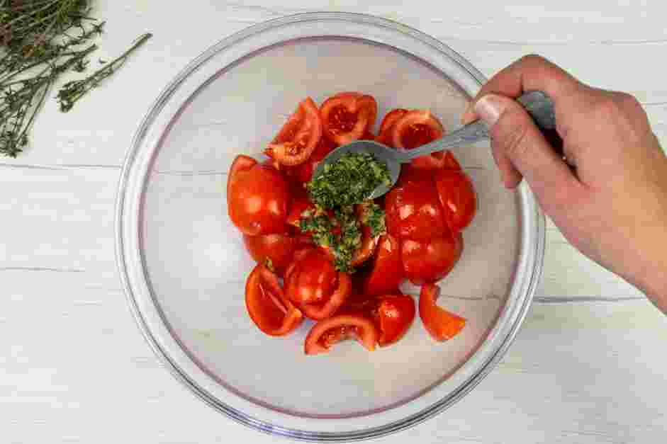 Tomato Confit Recipe: Add your marinade to the bowl with the quartered tomatoes and mix until all the tomatoes are nicely coated.