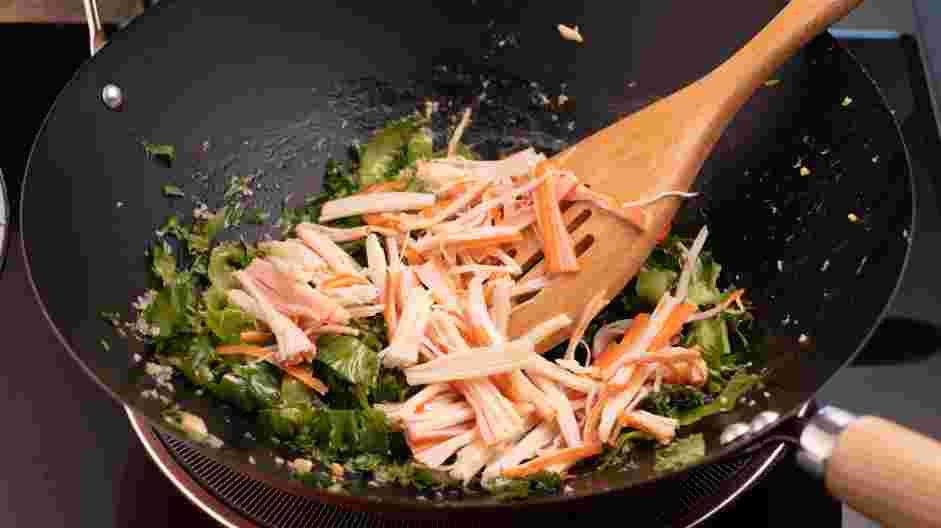 Crab Fried Rice Recipe: Add the chopped lettuce to the pan and cook until slightly wilted.