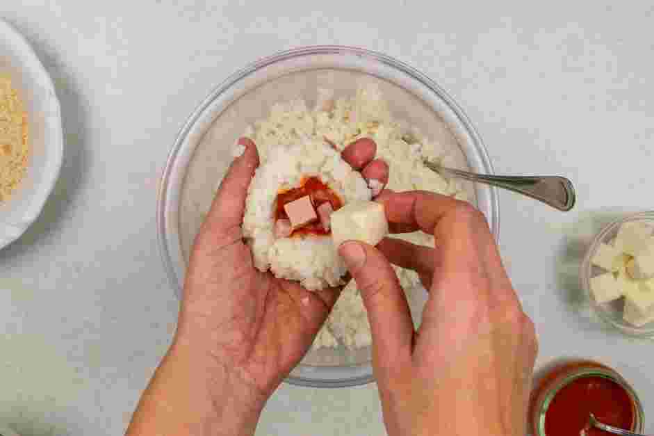 Italian Rice Balls Recipe: Once the rice is cooled, place a couple of tablespoons of rice at a time in your hand and flatten it into your cupped hand.