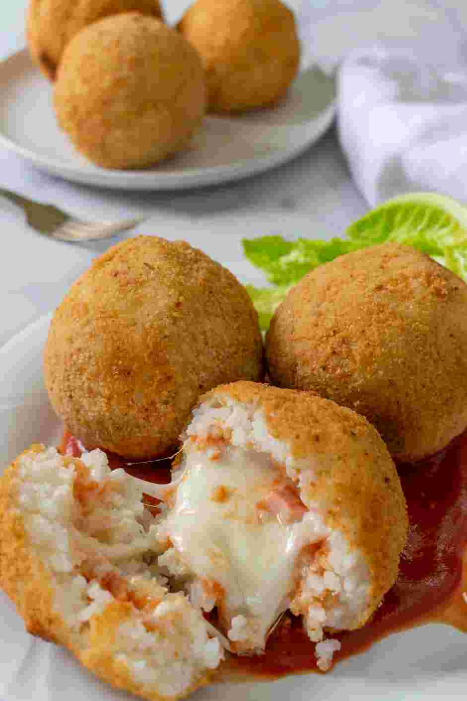 Italian Rice Balls Recipe: Enjoy the Italian rice balls hot and serve with additional marinara sauce.