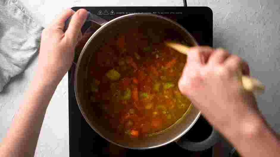 Maryland Crab Soup Recipe: Next, add the stock, wine, water, Worcestershire sauce, whole-grain mustard and canned cherry tomatoes to the soup pot with the vegetable base.