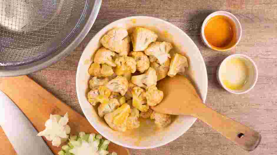 Air Fryer Buffalo Cauliflower Recipe: Toss the cauliflower in the Buffalo sauce until evenly coated.