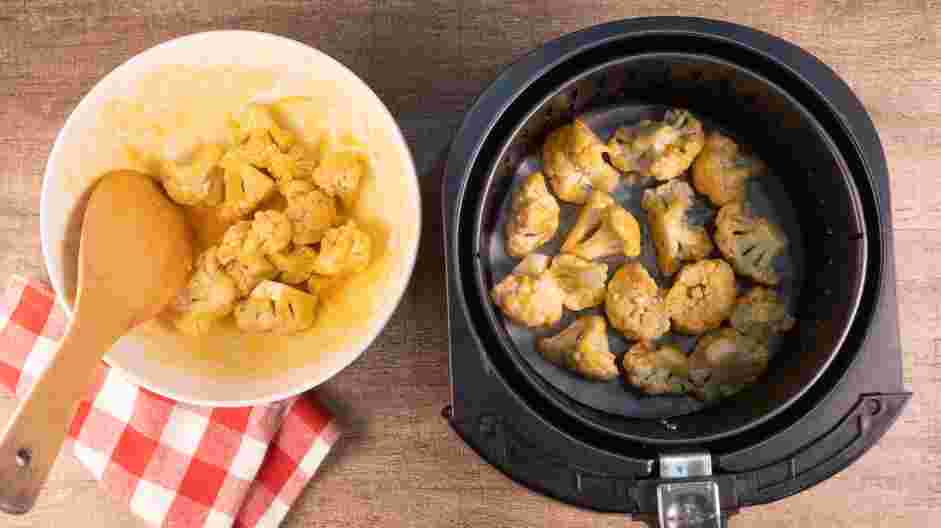 Air Fryer Buffalo Cauliflower Recipe: Arrange the Buffalo cauliflower inside the air fryer basket and cook for 15 minutes at 375°F, rotating halfway through the cooking time.