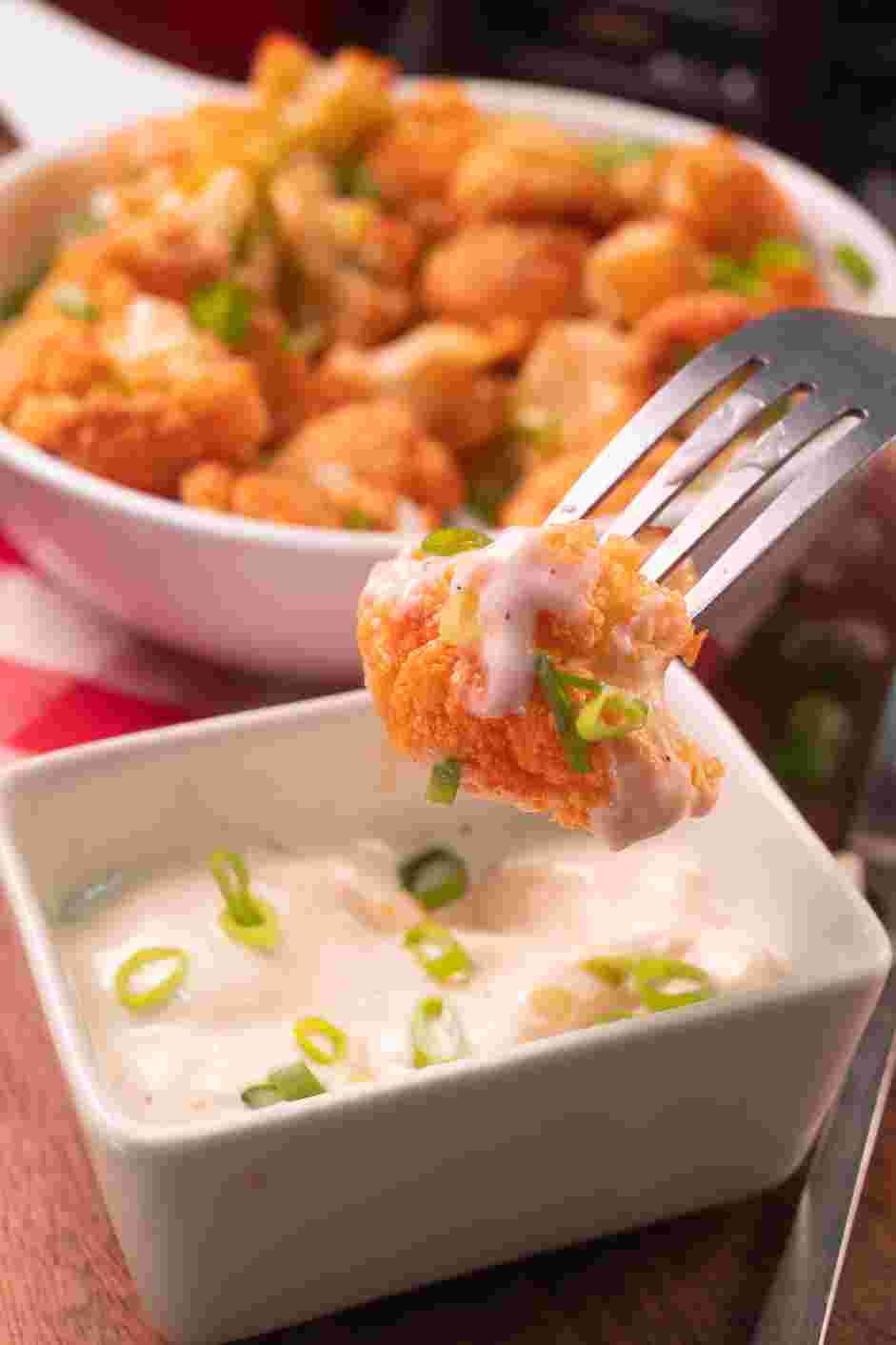 Air Fryer Buffalo Cauliflower Recipe: Garnish the air fryer Buffalo cauliflower with chopped green onions and serve with ranch or blue cheese dressing on the side.