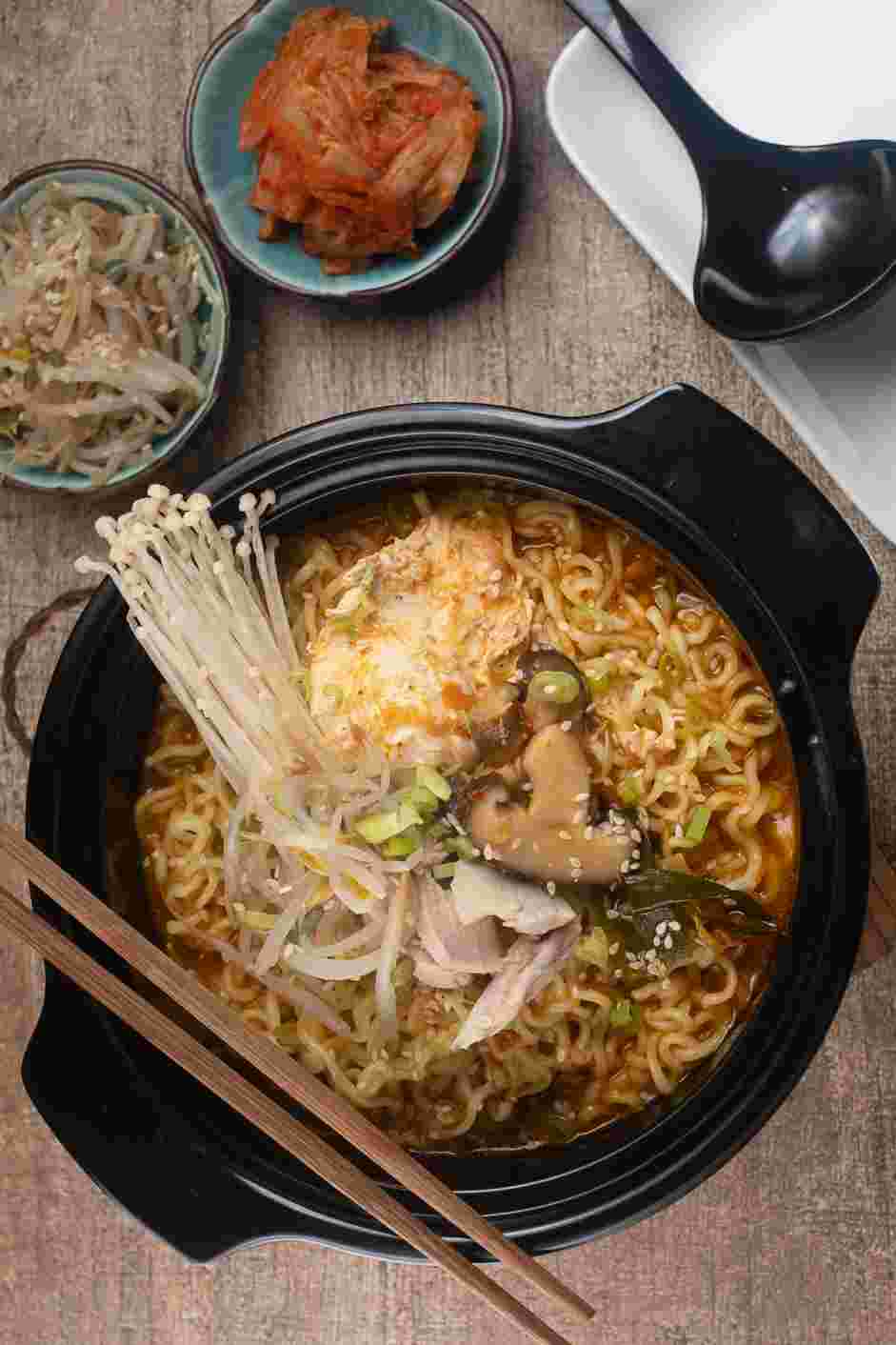 Korean Ramen Recipe: Top the Korean ramen with the chicken, seasoned bean sprouts, additional kimchi and chopped scallions.