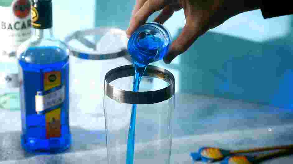 Shark Bite Cocktail Recipe: Layer the rum, club soda, vodka and blue Curaçao together in a pitcher.