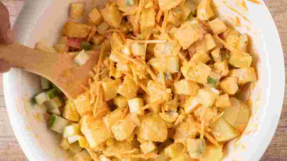 Korean Potato Salad Recipe: Add cooled diced potatoes, shredded carrots, diced hard boiled eggs, diced cucumbers and diced apple to the bowl.