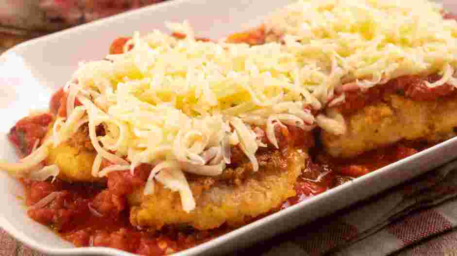 Keto Chicken Parmesan Recipe: Add some marinara sauce on the bottom of an oven-safe tray and transfer chicken on top.