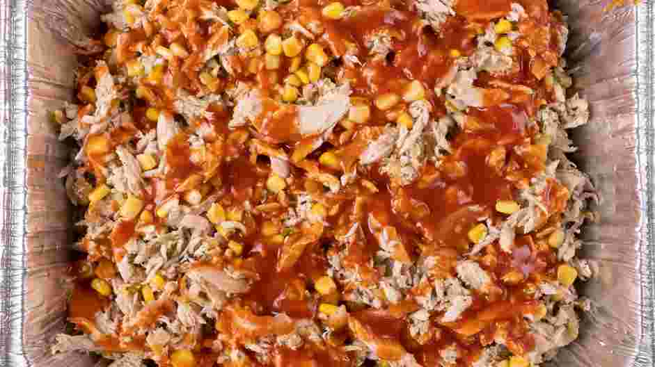 Chicken Taco Casserole Recipe: Evenly pour three ladles of the sauce over the chicken filling.