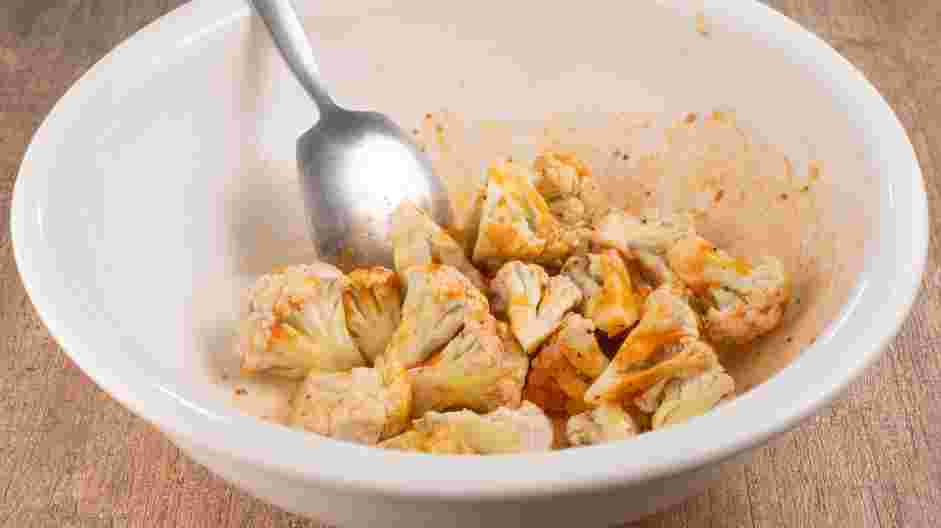 Buffalo Cauliflower Tacos Recipe: In a large mixing bowl, whisk together salt, black pepper, garlic powder, onion powder, hot sauce and coconut nectar (or honey) evenly.