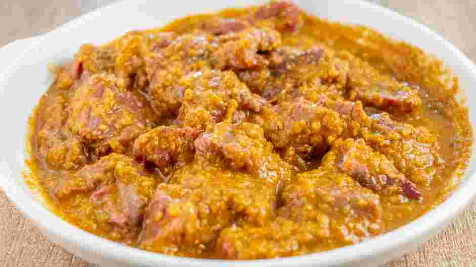 Lamb Vindaloo Recipe: Mix the lamb and paste in a large bowl and massage the paste well onto all sides of the lamb.