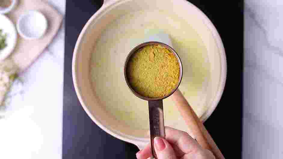 Vegan Pot Pie Recipe: Stir in the vegetable broth, coconut milk, nutritional yeast, potato, thyme, turmeric, salt and pepper.