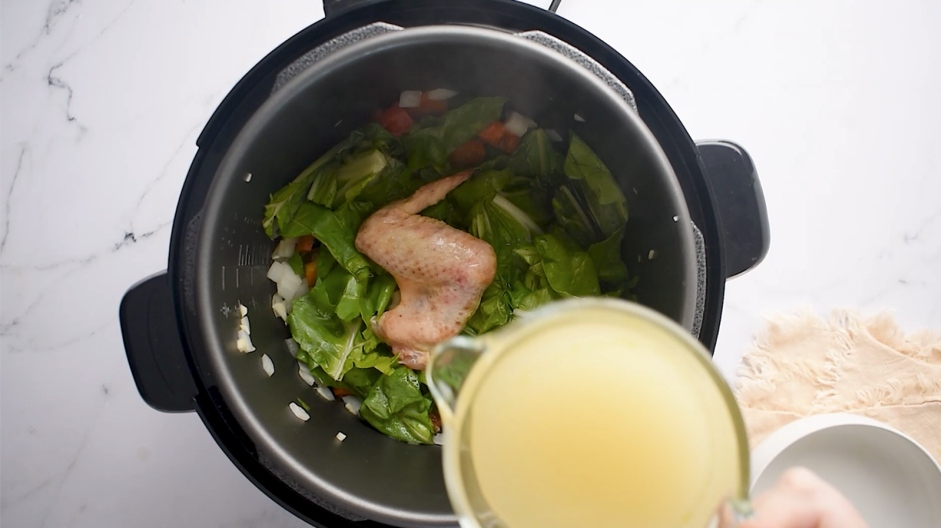 Instant Pot Collard Greens Recipe: Stir in the smoked turkey wing, vinegar, chicken broth and honey.