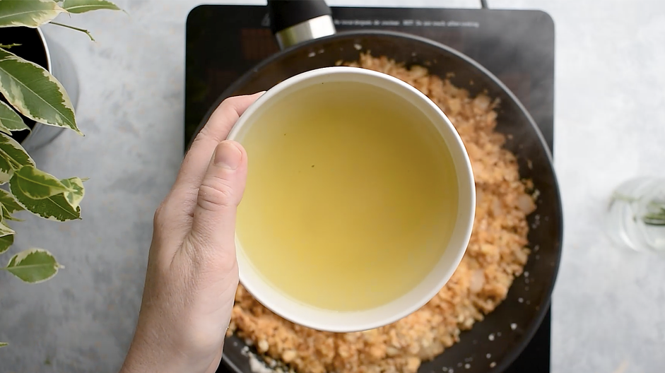 Spanish Cauliflower Rice Recipe: Add the chicken stock and cook for 3-5 minutes until the cauliflower rice is fully cooked.