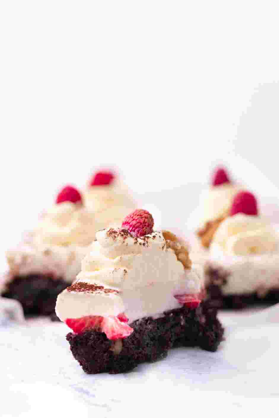 Raspberry Brownies Recipe: Garnish with whipped cream, walnuts, raspberries and cocoa powder.