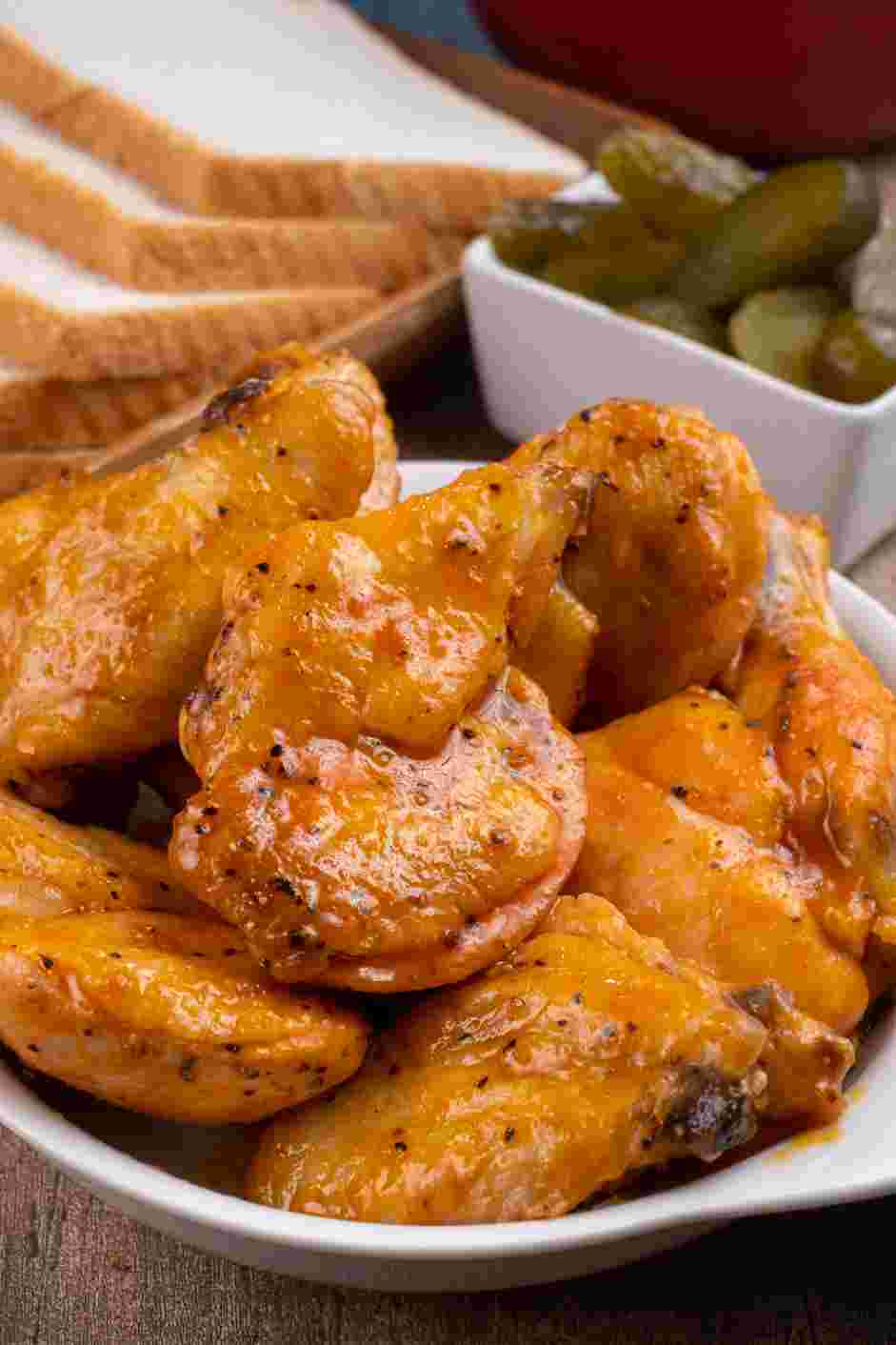 Air Fryer Chicken Wings Recipe: Serve the wings hot with dill pickle chips and slices of bread.