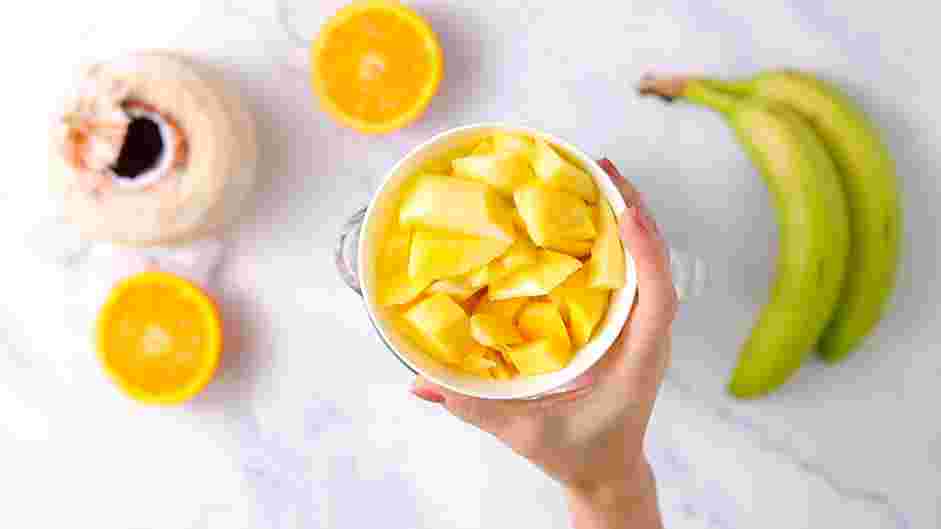 Mango Banana Smoothie Recipe: In a blender, pulse together the ice, frozen mangoes and almond milk until combined.