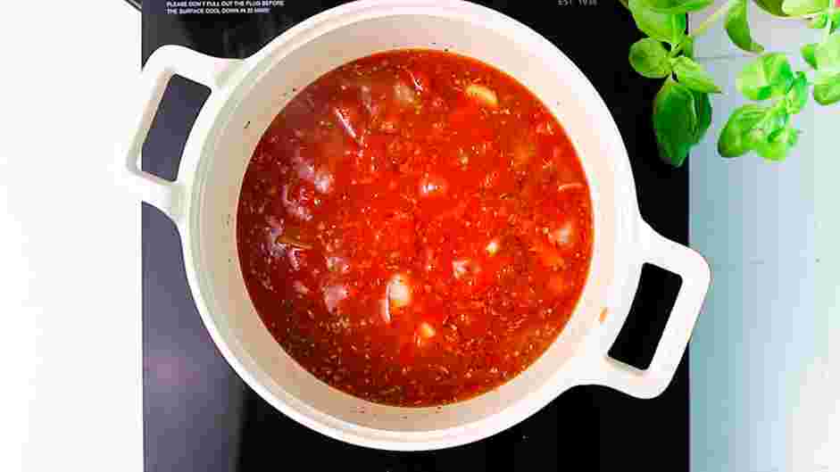 Vegan Eggplant Parmesan Recipe: Add the basil, oregano, garlic, salt, pepper and tomato sauce to the pot and simmer until slightly thickened, about 15 minutes.