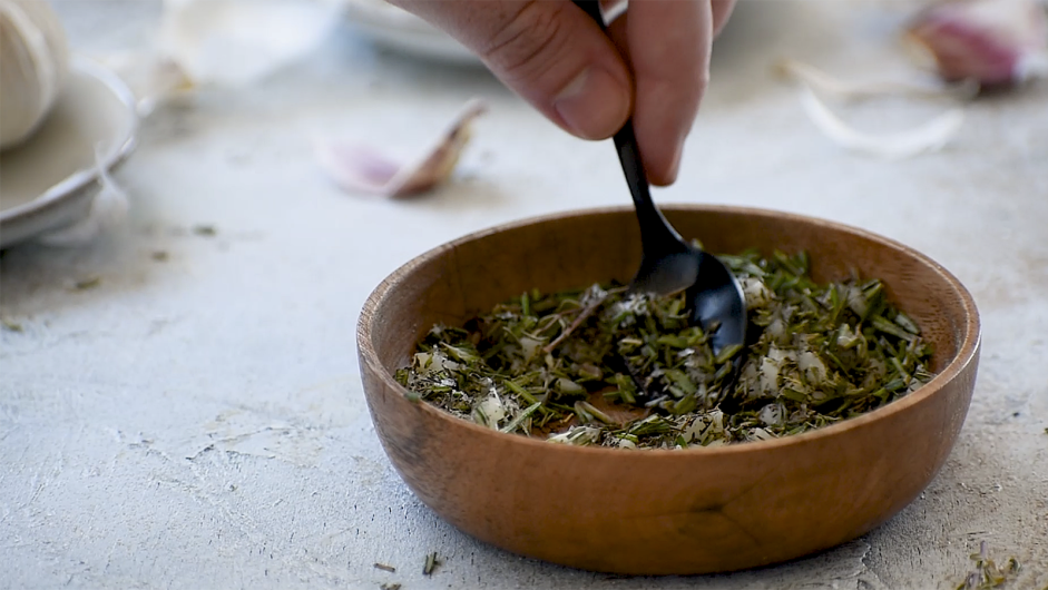 Herb-Crusted Lamb Lollipops Recipe: Mince garlic and mix together with rosemary and thyme.