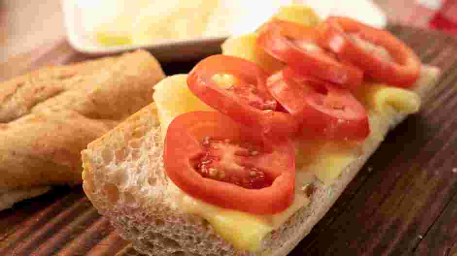 Caprese Panini Recipe: Cover the bread with an even layer of Roma tomatoes.