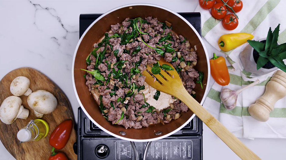 Keto Stuffed Mushrooms Recipe: Add the garlic and spinach and cook until the spinach is wilted.