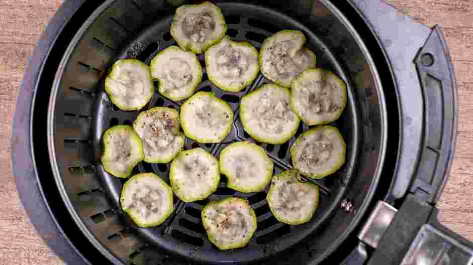 Air Fryer Zucchini Chips Recipe: Spray the inside of the air fryer basket with cooking spray and arrange the zucchini slices in a single layer, leaving a little space between each chip.