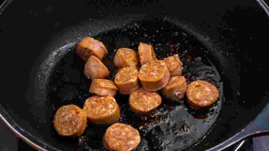 Cajun Chicken Alfredo Recipe: Add the andouille sausage to the same pan and cook until browned.