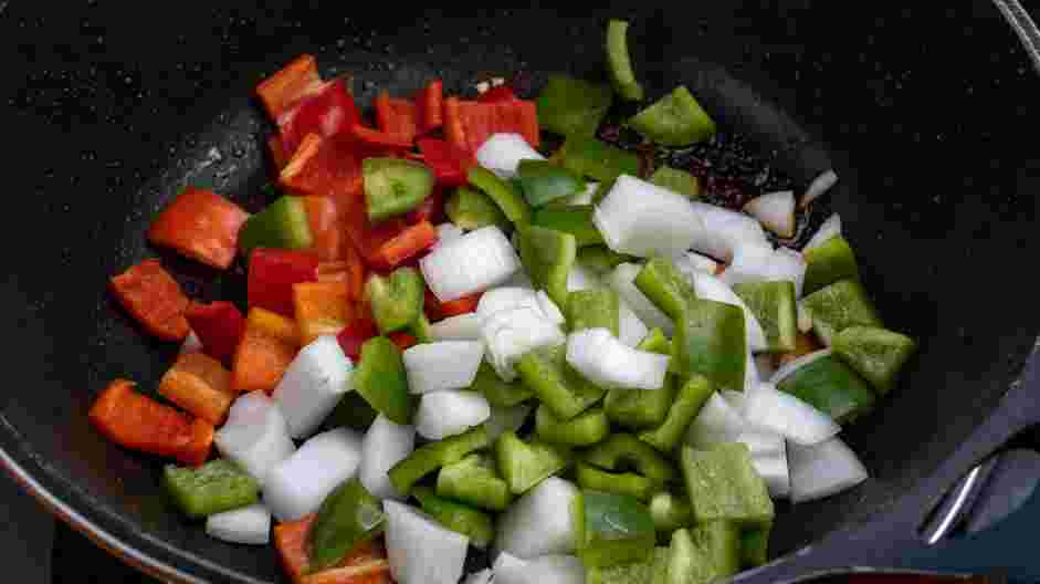 Cajun Chicken Alfredo Recipe: Add the onions, red and green bell peppers and cook until tender, 4-6 minutes.