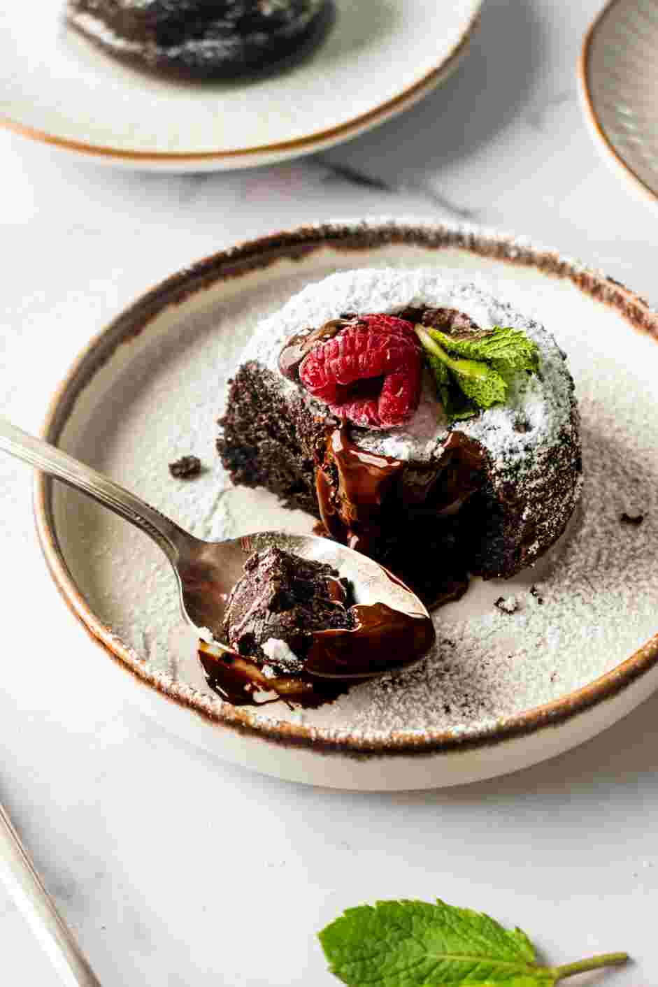 Chocolate Lava Cake Recipe: Top with powdered sugar, raspberries and mint leaves.