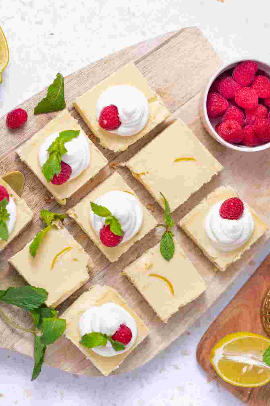 Lemon Cheesecake Bars Recipe: Garnish with whipped cream, raspberries and mint.