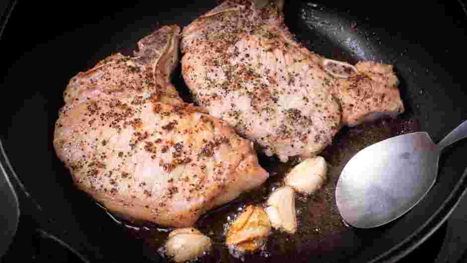 Skillet Pork Chops Recipe: 
Remove the skillet from the oven and add garlic cloves.