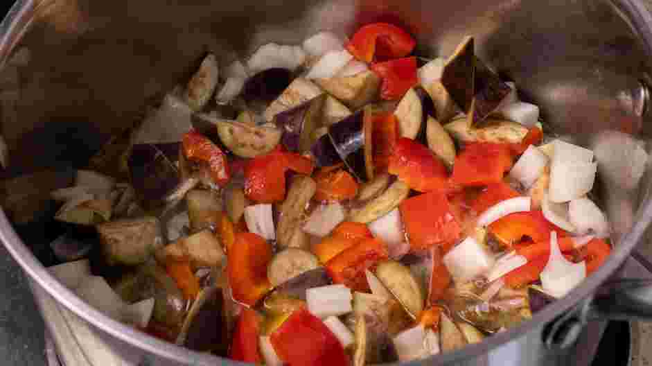 Eggplant Curry Recipe: Add the high-heat oil, eggplant, red bell pepper and onion to the pot and cook until all the vegetables are fully cooked and tender.