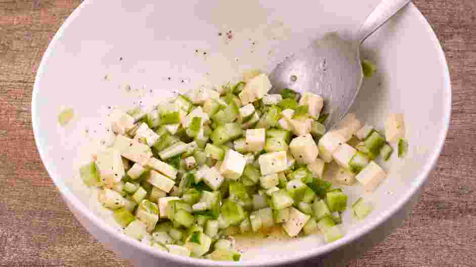 Greek Chicken Recipe: Add the feta cheese and the cucumber to the bowl and toss to coat.