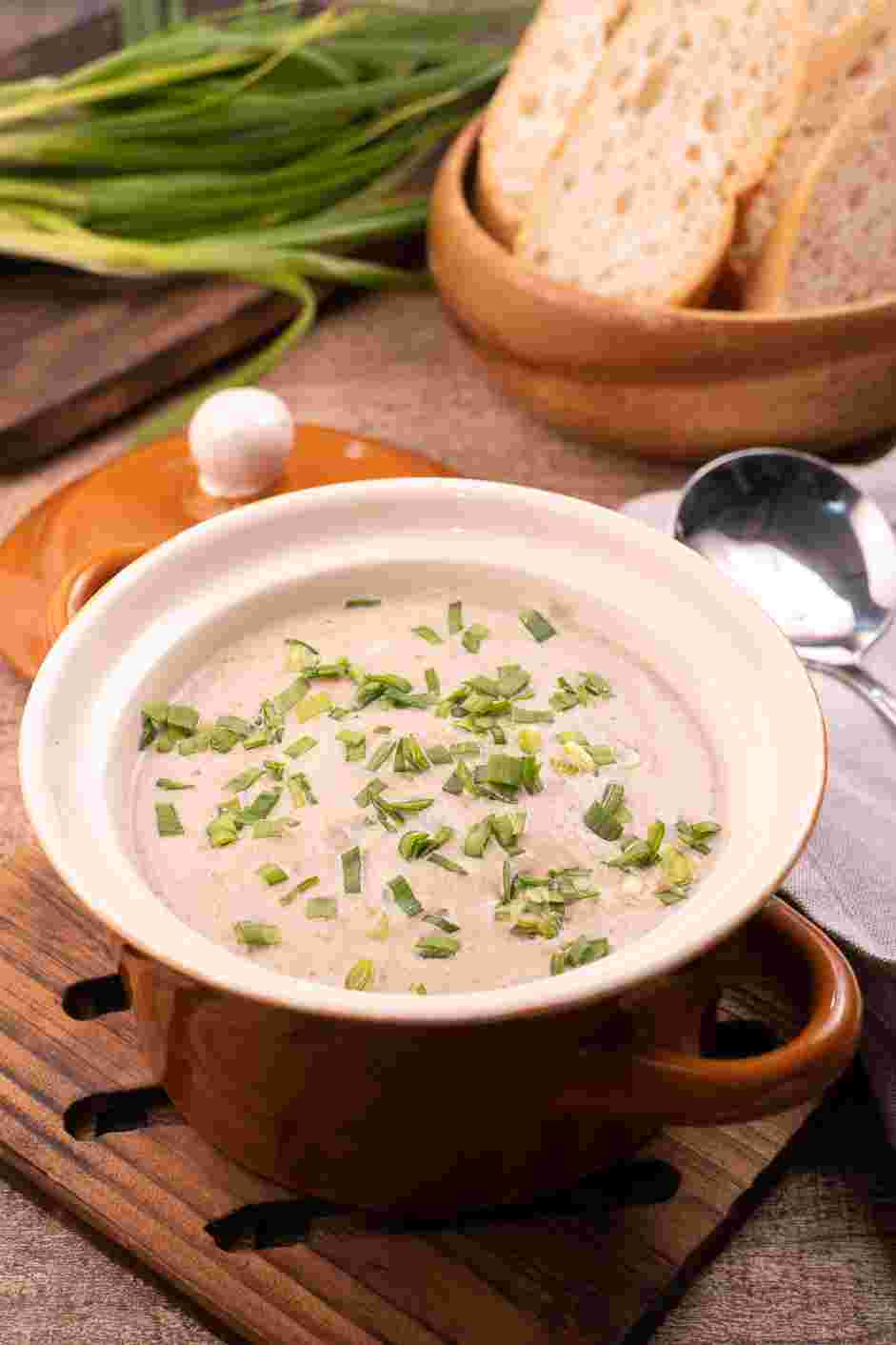 Mushroom Bisque Recipe: Ladle soup into bowls and top with chopped chives and lemon zest.