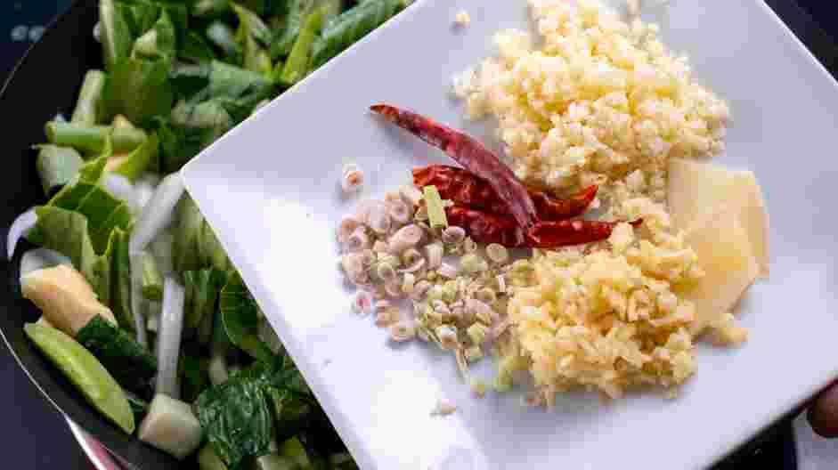 Thai Red Curry (Vegetarian) Recipe: Add the garlic, ginger, galangal root, dried chilies and lemongrass.