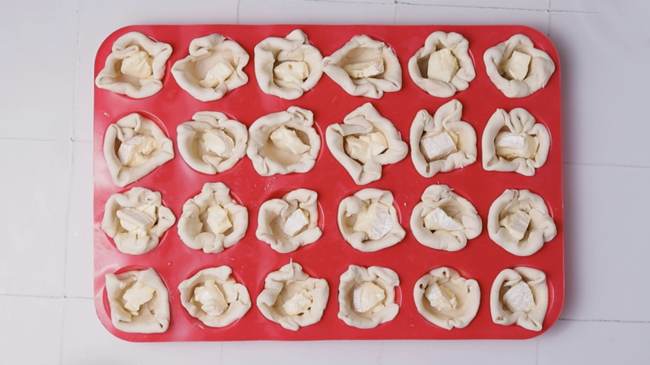 Cranberry Brie Bites Recipe: 
Remove the brie from the refrigerator and top the puff pastry with one square of brie.