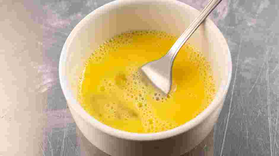 Mummy Dogs Recipe: In a small bowl, whisk together the egg and the water until well blended.