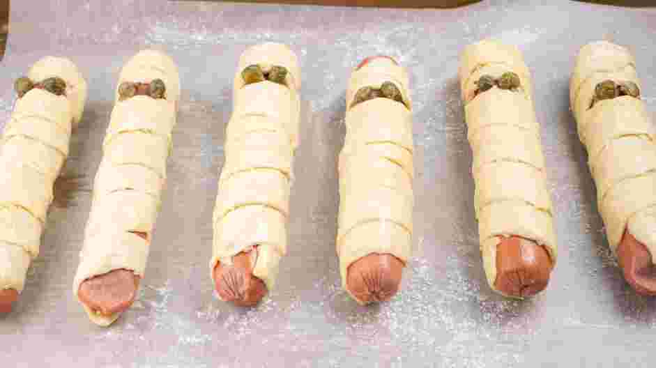 Mummy Dogs Recipe: Refrigerate the dough while you preheat the oven to 400&deg;F.