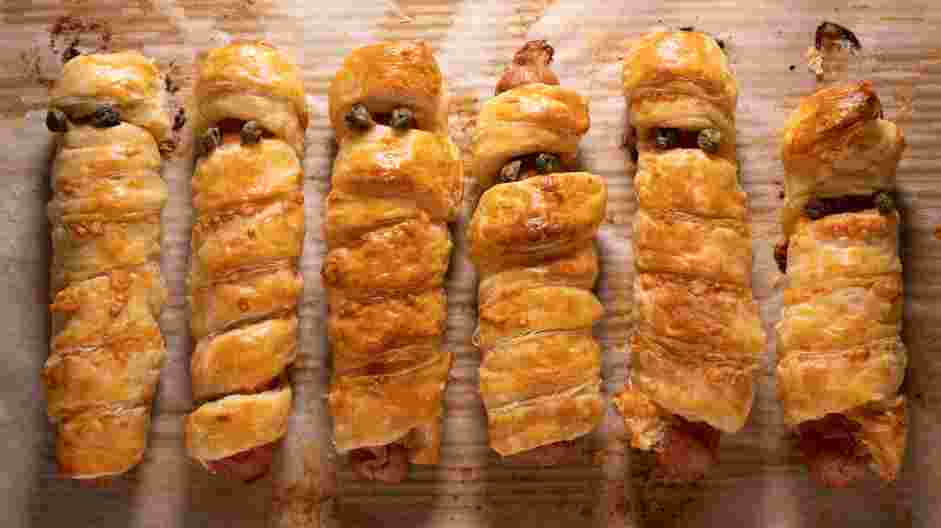 Mummy Dogs Recipe: Bake the mummy dogs for 18-20 minutes, or until the puff pastry is golden and the hot dog is heated through.