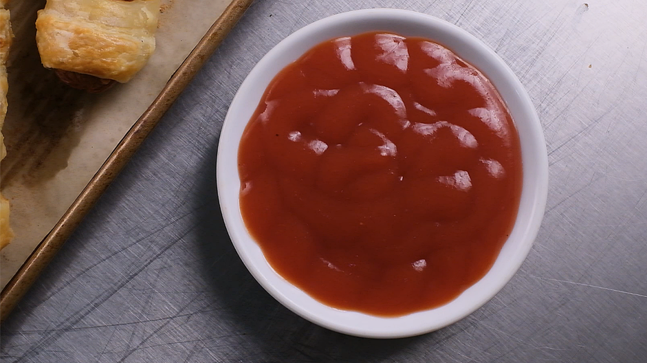 Mummy Dogs Recipe: While the hot dogs are baking, put together the spider web ketchup.